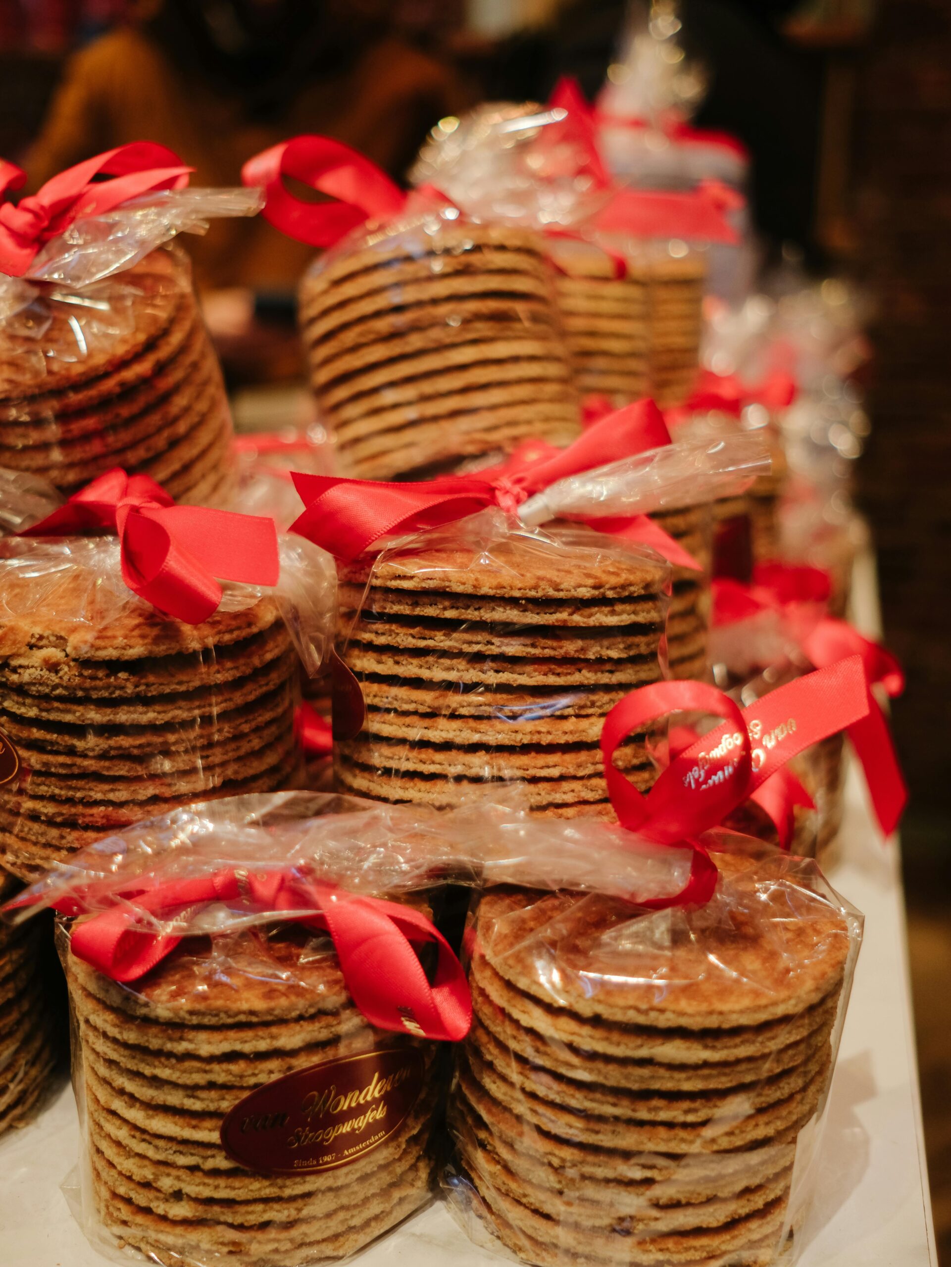 Delicious packaged stroopwafels tied with red ribbons, perfect for gifts or snacks.