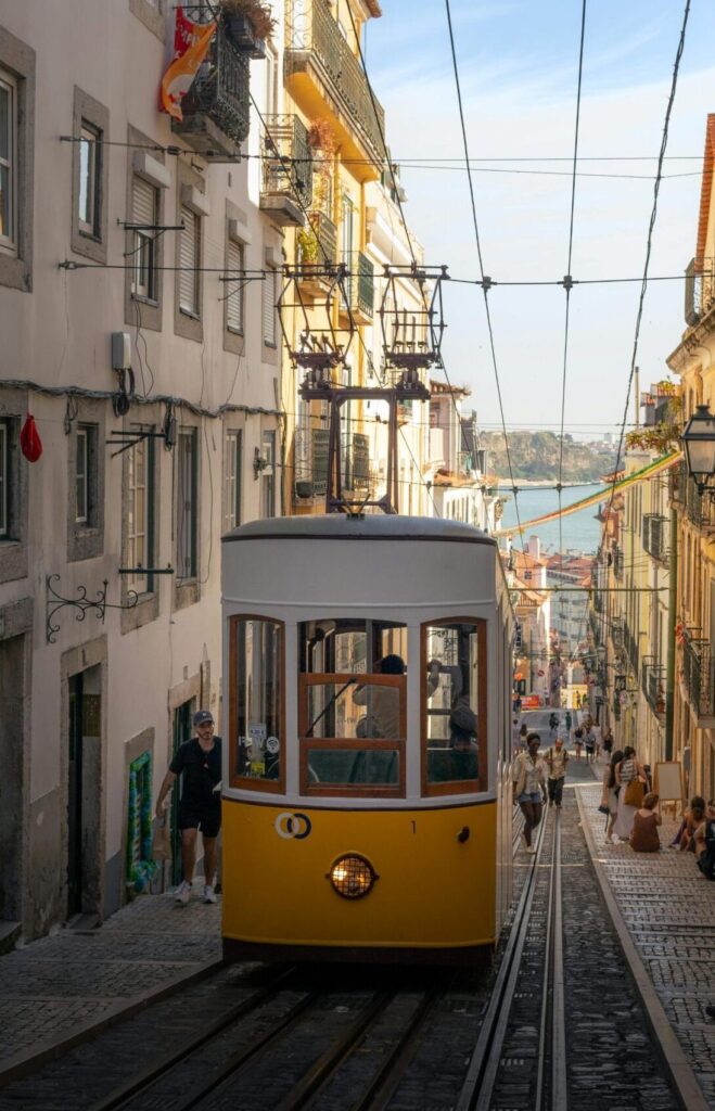 A classic yellow tram navigates a steep